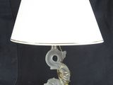 an image of a glass lamp with a white shade on a black background