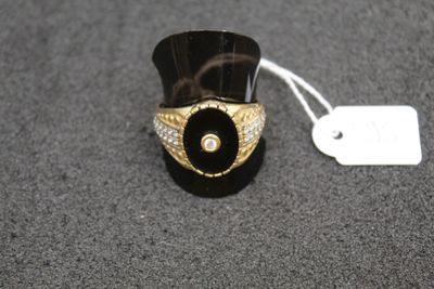 black and gold ring with a white diamond on top