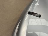 a sticker on the hood of a car that is parked in a parking lot