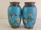 two blue vases with birds and flowers on them