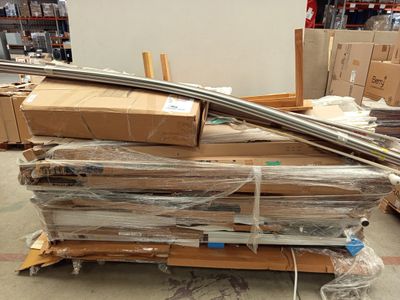 a pile of cardboard and cardboard boxes on a pallet in a warehouse