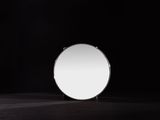 a mirror that is sitting on a table in the dark