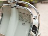 a close up view of a white motor scooter parked on the street