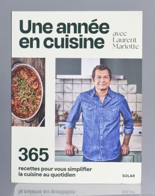 cookbook cover of a cookbook with a picture of a man standing in a kitchen
