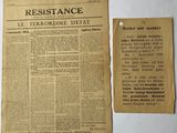 an old newspaper with a piece of paper next to it
