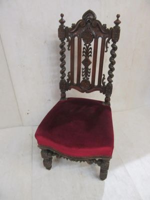 a red chair that is sitting on a white floor