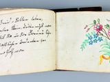 an open book with a drawing of flowers on it