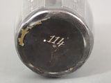 a close up of a silver vase with a number on it