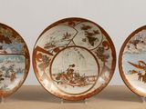 three plates with different designs on them sitting on a table