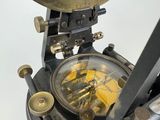 a close up of a clock that is on a stand