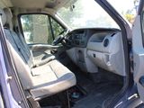 the interior of a truck with the door open and the driver ' s seat down