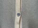 a close up of a sweater with buttons on it