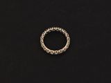 a silver ring on a black surface