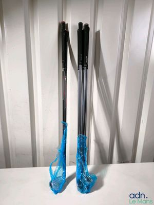 pair of black and blue skis sitting on top of a white table