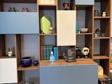 a shelf with many different items on it in a room