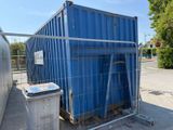 a blue container sitting in the middle of a parking lot