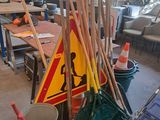 a pile of brooms and a mop on the floor