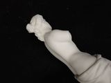 a white statue of a hand holding a flower