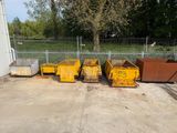 many yellow bins that are lined up in the yard