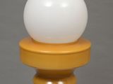 an image of a white and yellow lamp with a white ball on top