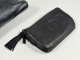 leather wallet with a tassel on a white surface