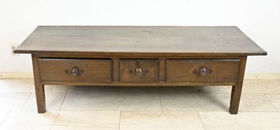 a coffee table with three drawers on top of it