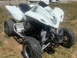 an image of a white quad bike parked in the grass