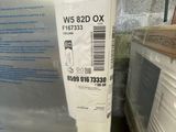 a white refrigerator sitting in a room next to a stack of boxes