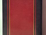 a red and black book with a gold border and a red cover