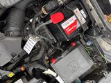 the engine compartment of a car with its hood open and the hood down