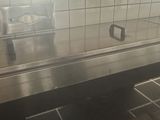 a man that is standing in a kitchen with a stove