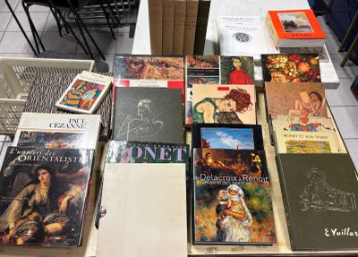 a lot of books on a table in a room