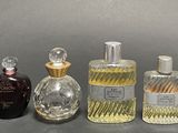several different types of perfume bottles lined up on a gray surface
