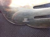 a metal fork that is on top of a piece of cloth