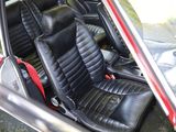 a red car with black leather seats in the back of it