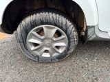 a white truck that has a flat tire on it