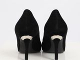 black high heeled shoes with a pointed toe on a white surface