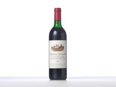 a bottle of red wine sitting on top of a table