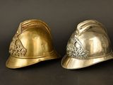 two helmets that are sitting next to each other on a table