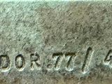 a close up of a metal plate with a name on it