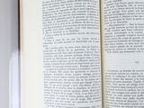 an open book with a yellow ribbon on it