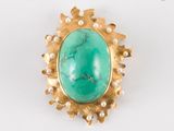 une photo d'une bague en or sertie d'une pierre turquoise et de perles