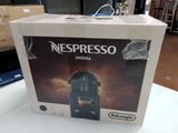 a box of nespresso espresso coffee machine on a table