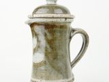 a close up of a coffee pot on a white surface