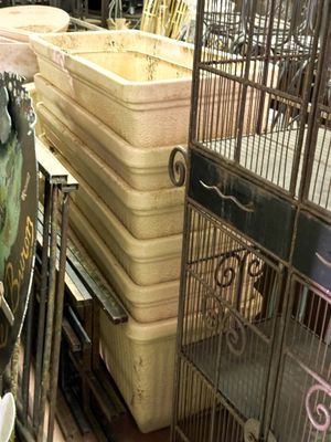 many cages with birds inside of them in a store