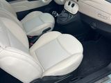 the interior of a small car with leather seats and a steering wheel