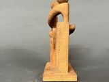 a small statue of a man holding a woman on his back