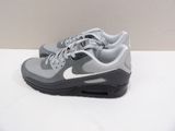 grey and white nike air max sneakers on a white surface