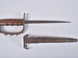 pair of antique wooden and metal knifes on a white surface