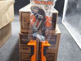 pair of orange scissors sitting on top of a stack of boxes